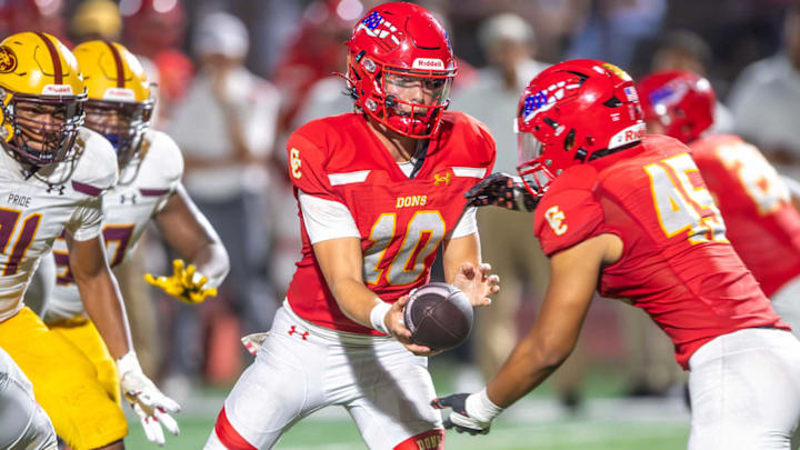 Cathedral Catholic QB Brady Palmer (10) hands the ball to Jonathan Solomon in 27-13 win over Mountain Pointe (Ariz.) in Sept. Honor Bowl game. 