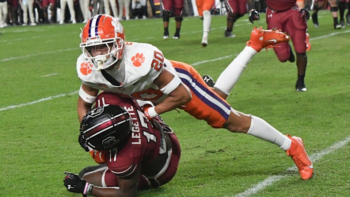 Clemson corner back Avieon Terrell (20) tackles South Carolina receiver Xavier Legette (17) 