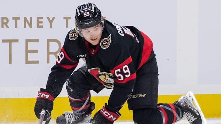 Mar 24, 2024; Ottawa, Ontario, CAN; Ottawa Senators left wing Angus Crookshank (59) falls to the ice in the first period against the Edmonton Oilers at the Canadian Tire Centre. Mandatory Credit: Marc DesRosiers-Imagn Images