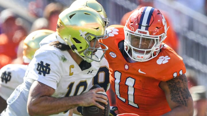 Notre Dame quarterback Sam Hartman (10) runs by Clemson defensive lineman Peter Woods (11) for a touchdown during the third quarter at Memorial Stadium in Clemson, S.C. Saturday, November 4, 2023.