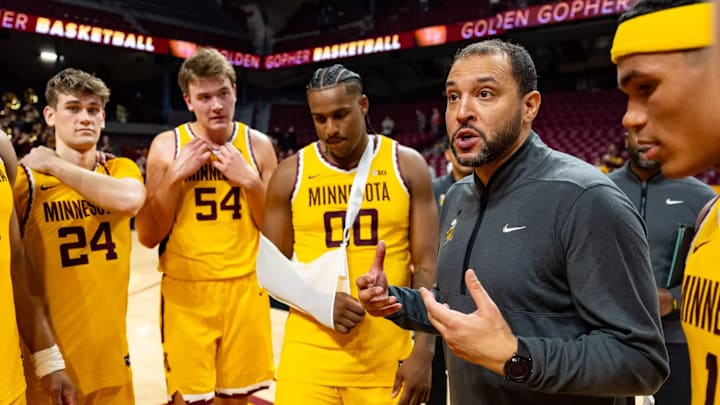 Frank Mitchell (00) wearing a sling for his right arm during a team huddle in Minnesota's exhibition win over Hamline. Frank Mitchell (00) wearing a sling for his right arm during a team huddle in Minnesota's exhibition win over Hamline.
