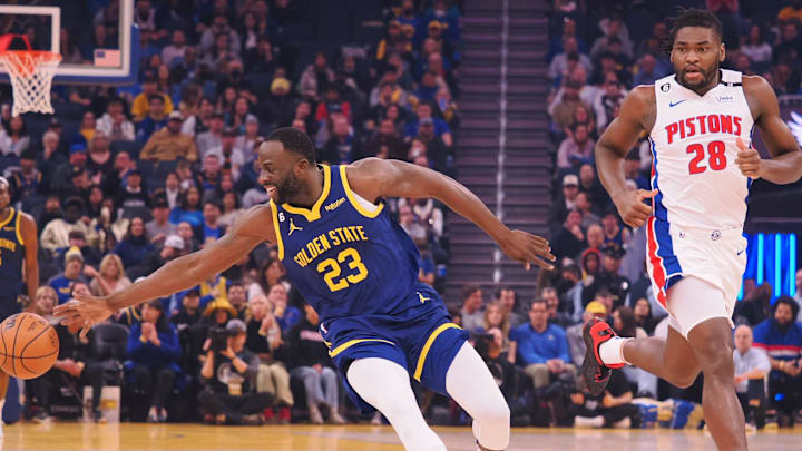 Jan 4, 2023; San Francisco, California, USA; Golden State Warriors forward Draymond Green (23) extends for the ball against Detroit Pistons center Isaiah Stewart (28) at Chase Center. Mandatory Credit: Kelley L Cox-Imagn Images