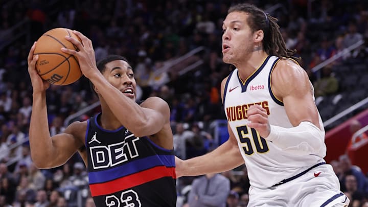 Nov 20, 2023; Detroit, Michigan, USA;  Detroit Pistons guard Jaden Ivey (23) is defended by Denver Nuggets forward Aaron Gordon (50): Rick Osentoski-Imagn Images