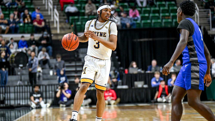 Wayne Memorial's Carlos Medlock Jr. moves the ball against Flint Carman-Ainsworth during the second quarter in the Division 1 state semifinal on Friday, March 14, 2025, at the Breslin Center in East Lansing.