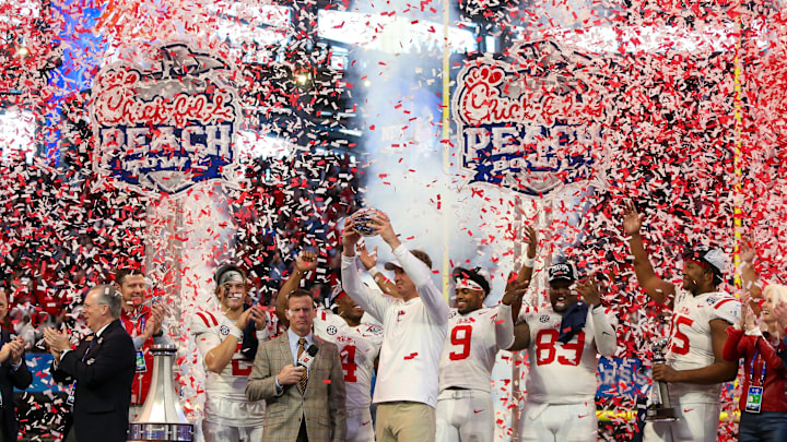 Dec 30, 2023; Atlanta, GA, USA; Mississippi Rebels head coach Lane Kiffin holds up the Peach Bowl