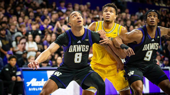 Bryson Tucker (8) and Wesley Yates III (9) block out a Michigan player. 