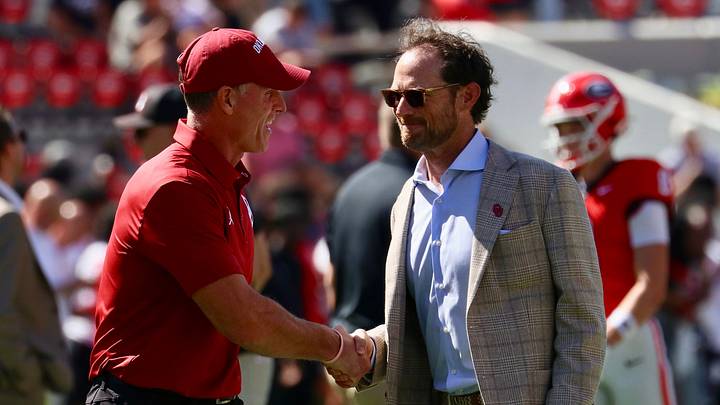 Oklahoma general manager Jim Nagy shakes hands with coach Brent Venables.