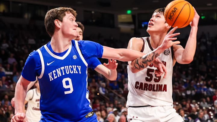 Feb 24, 2026; Columbia, South Carolina, USA; South Carolina Gamecocks guard Mike Sharavjamts (55) attempts to shoot over Kentucky Wildcats forward Trent Noah (9) during the first half at Colonial Life Arena. Mandatory Credit: Jeff Blake-Imagn Images