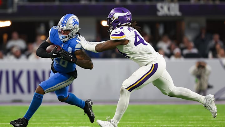 Dec 24, 2023; Minneapolis, Minnesota, USA; Detroit Lions running back Jahmyr Gibbs (26) runs the ball as Minnesota Vikings safety Josh Metellus (44) defends during the third quarter at U.S. Bank Stadium. Mandatory Credit: Matt Krohn-Imagn Images