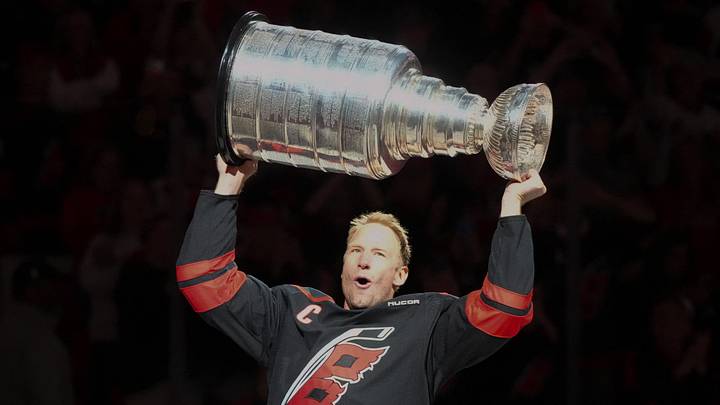 Sep 29, 2026; Raleigh, North Carolina, USA;  Carolina Hurricanes center Jordan Staal (11) hoists the Stanley Cup during a celebration and banner raising ceremony before a game against the Florida Panthers at Lenovo Center.  Mandatory Credit: James Guillory-Imagn Images