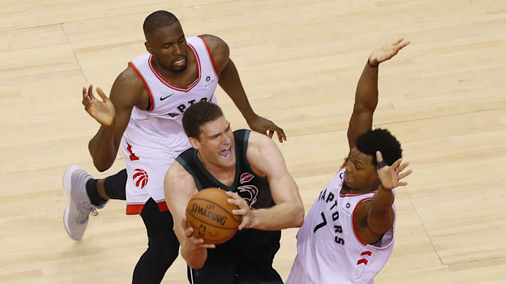 May 25, 2019; Toronto, Ontario, CAN: Toronto Raptors guard Kyle Lowry (7) and Raptors forward Serge Ibaka (9) defend against Milwaukee Bucks center Brook Lopez (11) during game six of the Eastern conference finals of the 2019 NBA Playoffs at Scotiabank Arena. Mandatory Credit: John E. Sokolowski-Imagn Images
