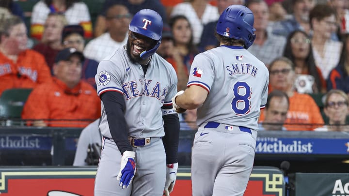 Jul 14, 2024; Houston, Texas, USA; Texas Rangers third baseman Josh Smith (8) celebrates with right fielder Adolis Garcia (53) after hitting a home run during the first inning against the Houston Astros at Minute Maid Park. Mandatory Credit: Troy Taormina-USA TODAY Sports