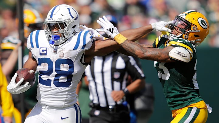 Indianapolis Colts running back Jonathan Taylor (28) stiff arms Green Bay Packers cornerback Jaire Alexander (23) on a first down run during their football game Sunday, September 15, 2024, at Lambeau Field in Green Bay, Wisconsin. Indianapolis Colts running back Jonathan Taylor (28) stiff arms Green Bay Packers cornerback Jaire Alexander (23) on a first down run during their football game Sunday, September 15, 2024, at Lambeau Field in Green Bay, Wisconsin.