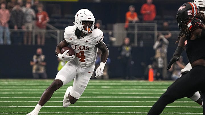Texas Longhorns running back CJ Baxter runs the ball during the Big 12 Championship game against the Oklahoma State Cowboys. Texas Longhorns running back CJ Baxter runs the ball during the Big 12 Championship game against the Oklahoma State Cowboys.