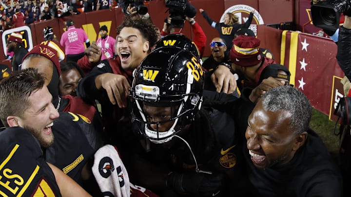 Oct 27, 2024; Landover, Maryland, USA; Washington Commanders wide receiver Noah Brown (85) celebrates with teammates after catching a game-winnning Hail Mary pass on the final play of the game against the Chicago Bears at Northwest Stadium. Mandatory Credit: Geoff Burke-Imagn Images