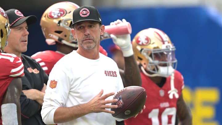 Sep 22, 2024; Inglewood, California, USA;  San Francisco 49ers head coach Kyle Shanahan looks on as players warm up prior to the game against the Los Angeles Rams at SoFi Stadium. Mandatory Credit: Jayne Kamin-Oncea-Imagn Images