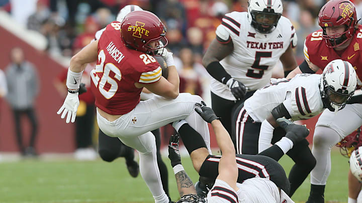 Iowa State running back Carson Hansen (26) battles for few yards as he gets tackled by Texas Tech's Jacob Rodriguez (10) during their game at Jack Trice Stadium on Saturday, Nov. 2, 2024, in Ames, Iowa.