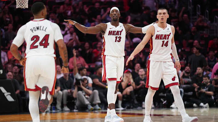 Dec 1, 2025; Miami, Florida, USA; Miami Heat center Bam Adebayo (13), guard Norman Powell (24) and guard Tyler Herro (14) get back on defense against the Los Angeles Clippers during the second half at Kaseya Center. Mandatory Credit: Jim Rassol-Imagn Images