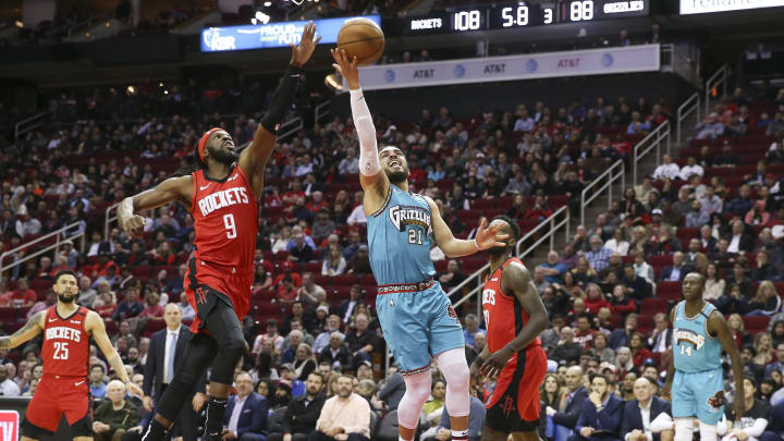 Feb 26, 2020; Houston, Texas, USA; Memphis Grizzlies guard Tyus Jones (21) shoots against Houston Rockets forward DeMarre Carroll (9) in the second half at Toyota Center. Mandatory Credit: Thomas Shea-USA TODAY Sports