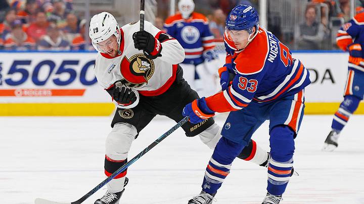 Mar 3, 2026; Edmonton, Alberta, CAN; Edmonton Oilers forward Ryan Nugent-Hopkins (93) and Ottawa Senators forward Drake Batherson (19) battle for a loose puck during the third period at Rogers Place. Mandatory Credit: Perry Nelson-Imagn Images