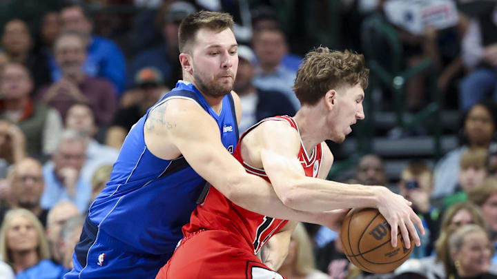 Nov 6, 2024; Dallas, Texas, USA;  Dallas Mavericks guard Luka Doncic (77) tries to steal the ball from Chicago Bulls forward Matas Buzelis (14)
