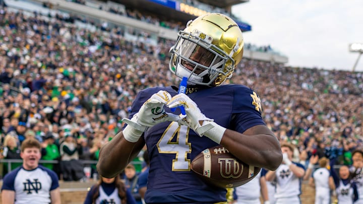 Nov 22, 2025; South Bend, Indiana, USA; Notre Dame Fighting Irish running back Jeremiyah Love (4) celebrates scoring against the Syracuse Orange during the first half at Notre Dame Stadium. Mandatory Credit: Michael Caterina-Imagn Images