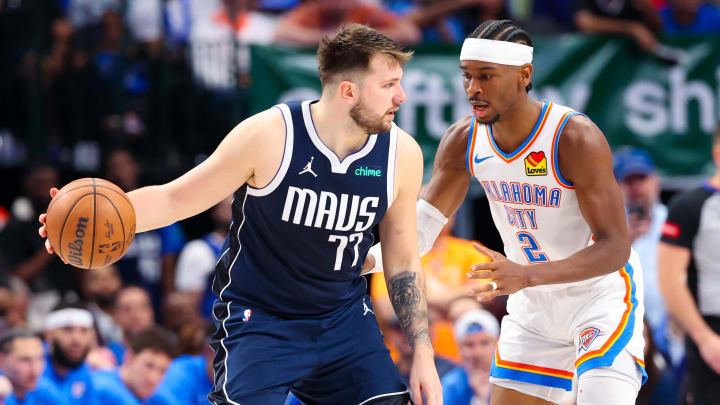 May 11, 2024; Dallas, Texas, USA; Dallas Mavericks guard Luka Doncic (77) controls the ball as Oklahoma City Thunder guard Shai Gilgeous-Alexander (2) defends during the second half during game three of the second round for the 2024 NBA playoffs at American Airlines Center. Mandatory Credit: Kevin Jairaj-USA TODAY Sports
