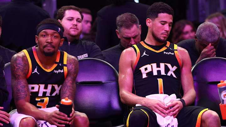 Apr 9, 2025; Phoenix, Arizona, USA; Phoenix Suns guard Bradley Beal (3) and guard Devin Booker (1) react on the bench against the Oklahoma City Thunder during the second half at Footprint Center. Mandatory Credit: Mark J. Rebilas-Imagn Images