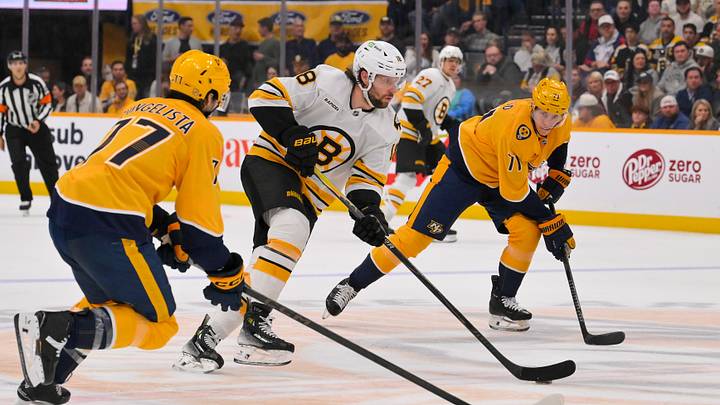 Mar 5, 2026; Nashville, Tennessee, USA; Boston Bruins center Pavel Zacha (18) splits Nashville Predators center Tyson Jost (17) and right wing Matthew Wood (71) during the second period at Bridgestone Arena. Mandatory Credit: Steve Roberts-Imagn Images Mar 5, 2026; Nashville, Tennessee, USA; Boston Bruins center Pavel Zacha (18) splits Nashville Predators center Tyson Jost (17) and right wing Matthew Wood (71) during the second period at Bridgestone Arena. Mandatory Credit: Steve Roberts-Imagn Images