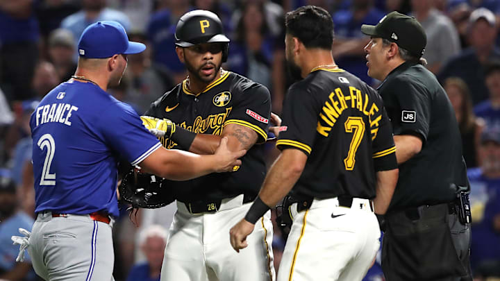 Aug 18, 2025; Pittsburgh, Pennsylvania, USA;  Pittsburgh Pirates left fielder Tommy Pham (middle) is restrained by Toronto Blue Jays first baseman Ty France (2) after Pham took exception to a comment by Toronto catcher Tyler Heineman (not pictured) during the seventh inning at PNC Park. Mandatory Credit: Charles LeClaire-Imagn Images