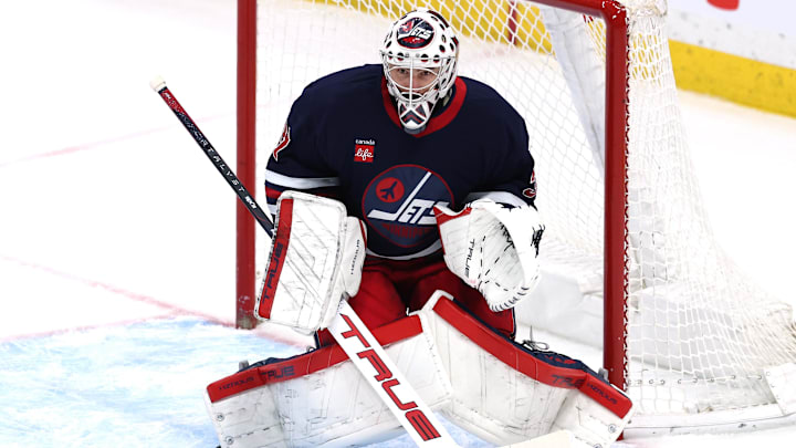 Mar 28, 2025; Winnipeg, Manitoba, CAN; Winnipeg Jets goaltender Connor Hellebuyck (37) eyes an incoming shot from the New Jersey Devils in the third period at Canada Life Centre. Mandatory Credit: James Carey Lauder-Imagn Images
