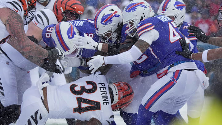 Cincinnati Bengals running back Samaje Perine heads into a wall of Bills players, Buffalo Bills defensive tackle Deone Walker, linebacker Dorian Williams, and cornerback Christian Benford during first half action at Highmark Stadium in Orchard Park on Dec. 7, 2025. Cincinnati Bengals running back Samaje Perine heads into a wall of Bills players, Buffalo Bills defensive tackle Deone Walker, linebacker Dorian Williams, and cornerback Christian Benford during first half action at Highmark Stadium in Orchard Park on Dec. 7, 2025.
