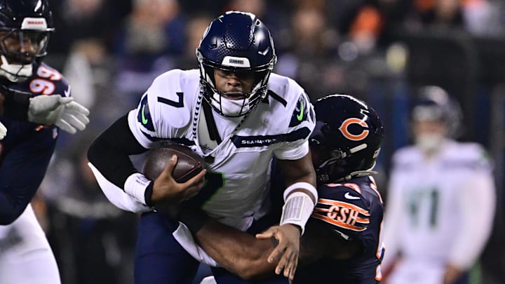 Dec 26, 2024; Chicago, Illinois, USA; Seattle Seahawks quarterback Geno Smith (7) is sacked by Chicago Bears defensive tackle Byron Cowart (93) during the second quarter at Soldier Field. Mandatory Credit: Daniel Bartel-Imagn Images