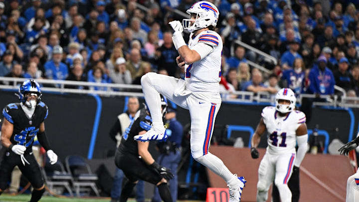 Buffalo Bills quarterback Josh Allen leaps across the goal line for his second touchdown of the game against the Detroit Lions