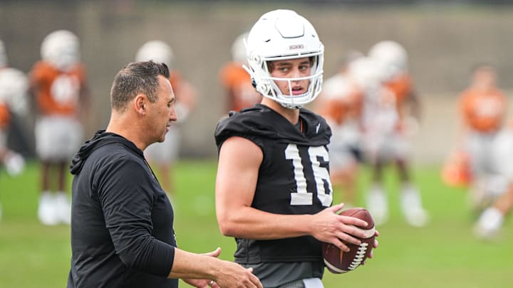 Head coach Steve Sarkisian talks to quarterback Arch Manning during the first Texas Longhorns football practice of 2023.