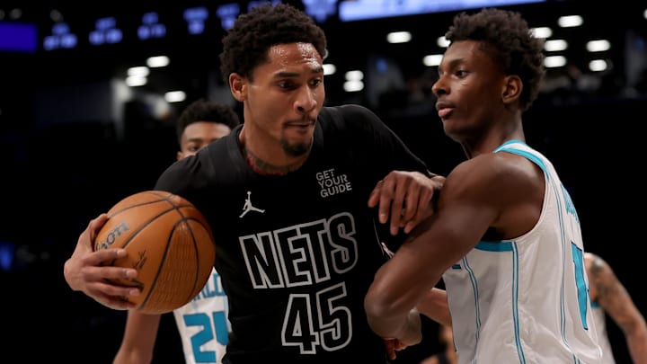 Nov 19, 2024; Brooklyn, New York, USA; Brooklyn Nets guard Keon Johnson (45) controls the ball against Charlotte Hornets forward Moussa Diabate (14) during the third quarter at Barclays Center. Mandatory Credit: Brad Penner-Imagn Images