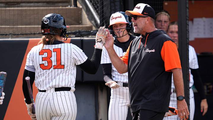Oklahoma State coach Kenny Gajewski celebrates with Oklahoma State Cowgirls infielder Lexi McDonald. Oklahoma State coach Kenny Gajewski celebrates with Oklahoma State Cowgirls infielder Lexi McDonald.