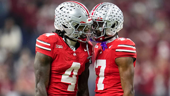 Ohio State Buckeyes wide receiver Jeremiah Smith (4) celebrates with wide receiver Carnell Tate (17) during the first half of the Big Ten Conference championship game against the Indiana Hoosiers at Lucas Oil Stadium in Indianapolis on Dec. 6, 2025.