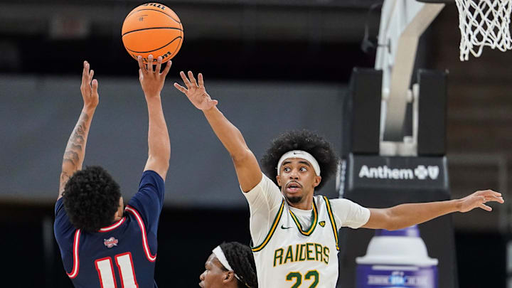 Detroit Mercy Titans guard Lance Stone and Wright State Raiders guard TJ Burch 