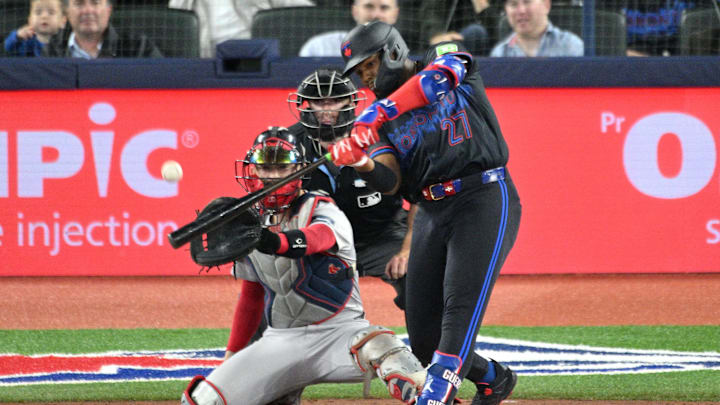 Sep 25, 2024; Toronto, Ontario, CAN;  Toronto Blue Jays first baseman Vladimir Guerrero Jr. (27) hits a double against the Boston Red Sox in the fourth inning at Rogers Centre. Mandatory Credit: Dan Hamilton-Imagn Images