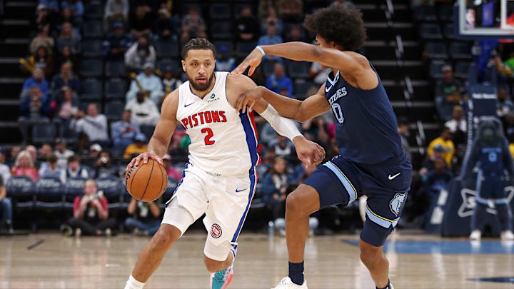 Nov 3, 2025; Memphis, Tennessee, USA; Detroit Pistons guard Cade Cunningham (2) dribbles as Memphis Grizzlies forward Jaylen Wells (0) during the first quarter at FedExForum. Mandatory Credit: Petre Thomas-Imagn Images
