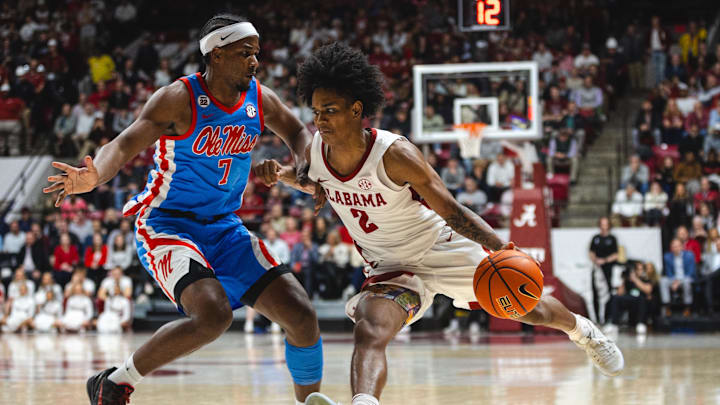 Jan 14, 2025; Tuscaloosa, Alabama, USA; Alabama Crimson Tide guard Aden Holloway (2) works against Mississippi Rebels guard Davon Barnes (7) during the second half at Coleman Coliseum. Mandatory Credit: Will McLelland-Imagn Images