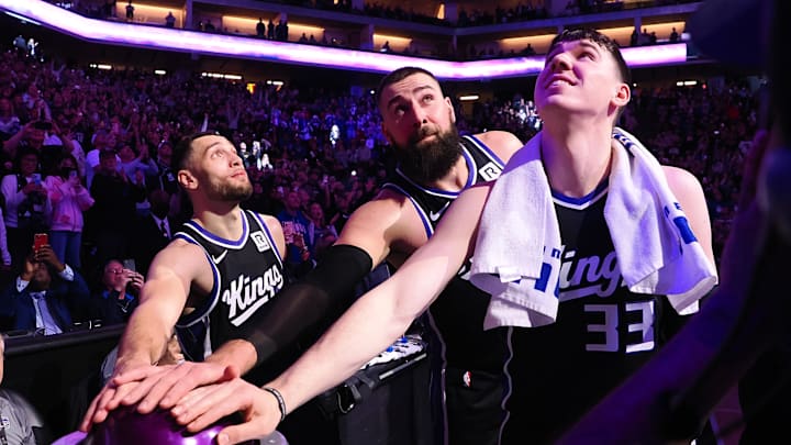 Feb 8, 2025; Sacramento, California, USA; Sacramento Kings guard Zach LaVine (8), center Jonas Valaciunas (17) and forward Jake LaRavia (33) look up after pushing the button to light the beam after a win against the New Orleans Pelicans at Golden 1 Center. Mandatory Credit: Kelley L Cox-Imagn Images