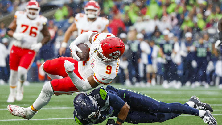 Aug 15, 2025; Seattle, Washington, USA; Seattle Seahawks quarterback Jalen Milroe (6) tackles Kansas City Chiefs wide receiver JuJu Smith-Schuster (9) short of a first down during the first quarter at Lumen Field. Mandatory Credit: Joe Nicholson-Imagn Images