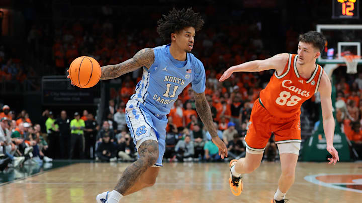 Feb 10, 2026; Coral Gables, Florida, USA; North Carolina Tar Heels forward Jonathan Powell (11) drives to the basket against Miami Hurricanes forward Timotej Malovec (88) during the second half at Watsco Center. Mandatory Credit: Sam Navarro-Imagn Images