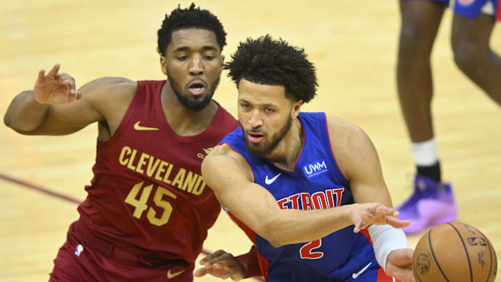 Jan 31, 2024; Cleveland, Ohio, USA; Detroit Pistons guard Cade Cunningham (2) throws a pass beside Cleveland Cavaliers guard Donovan Mitchell (45) in the fourth quarter at Rocket Mortgage FieldHouse. Mandatory Credit: David Richard-Imagn Images