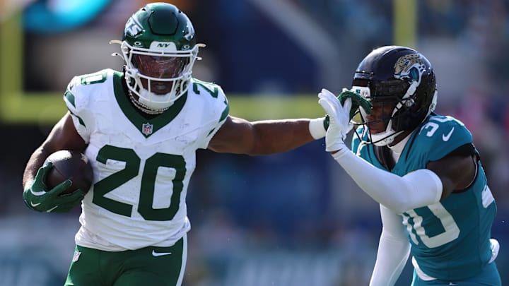 Dec 14, 2025; Jacksonville, Florida, USA; New York Jets running back Breece Hall (20) runs with the ball against Jacksonville Jaguars cornerback Montaric Brown (30) during the first quarter at EverBank Stadium. Mandatory Credit: Morgan Tencza-Imagn Images