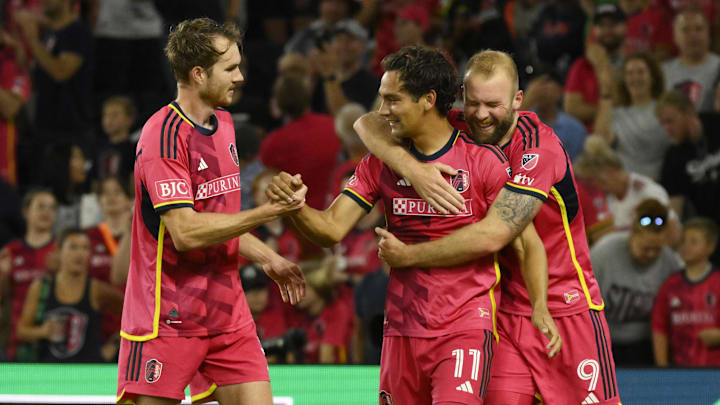 St. Louis CITY SC forward Simon Becher (11) celebrates with defender Henry Kessler (5) and forward Joao Klauss (9) after scoring a goal against Houston Dynamo 