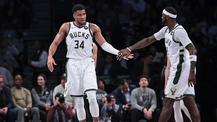 Dec 27, 2023; Brooklyn, New York, USA; Milwaukee Bucks forward Giannis Antetokounmpo (34) slaps hands with forward Bobby Portis (9) during the first half against the Brooklyn Nets at Barclays Center. Mandatory Credit: Vincent Carchietta-Imagn Images