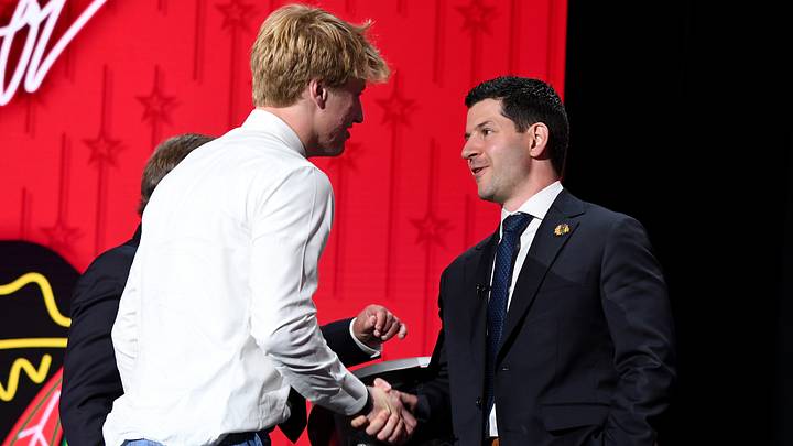 Jun 28, 2023; Nashville, Tennessee, USA; Chicago Blackhawks draft pick Oliver Moore shakes hands with general manager Kyle Davidson after being selected with the nineteenth pick in round one of the 2023 NHL Draft at Bridgestone Arena. Mandatory Credit: Christopher Hanewinckel-USA TODAY Sports